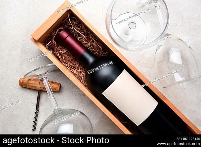 Cabernet Wine Still Life: A bottle in wood case with glasses and corkscrew