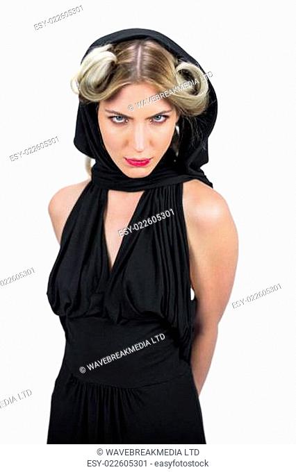 Frowning creepy blonde wearing black clothes posing