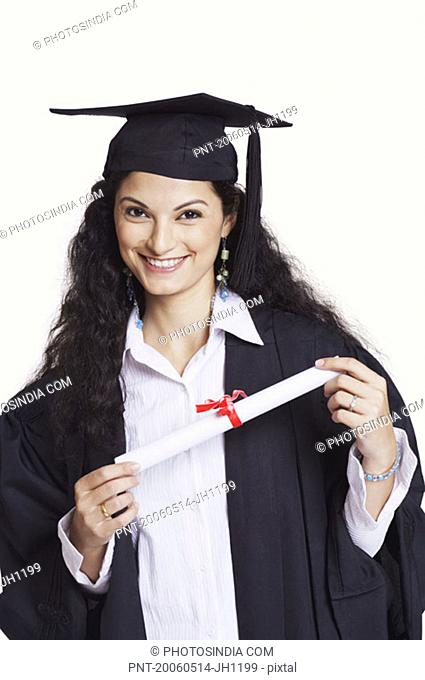 Portrait of a female graduate holding a diploma and smiling