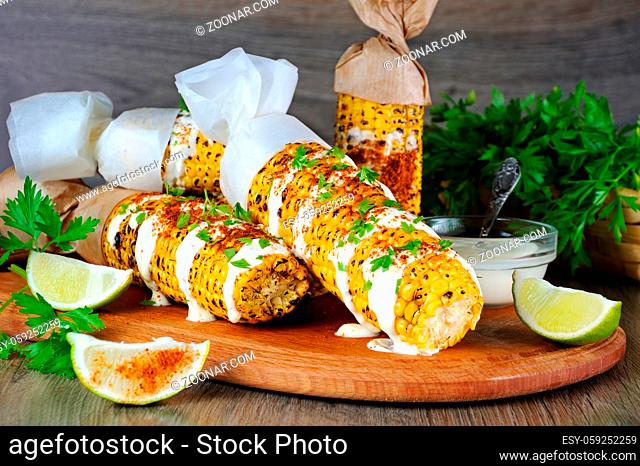 Delicious fried corn, grated with lime, poured with sauce and seasoned with spicy spices. Indian and Mexican style