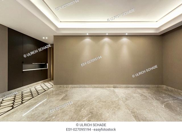 Empty room with marble flooring and beige wall paper decoration