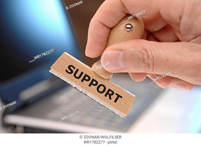 support marked on rubber stamp in hand