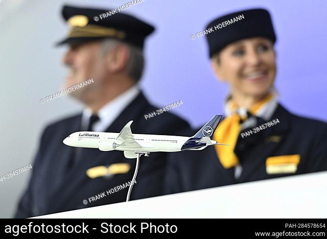 Airplane model of a Lufthansa passenger plane in the background are flight attendants, stewardess, steward. Lufthansa aircraft christening Airbus A350 MUENCHEN...