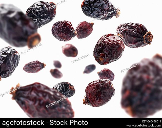 Dried rosehip berries levitate on a white background