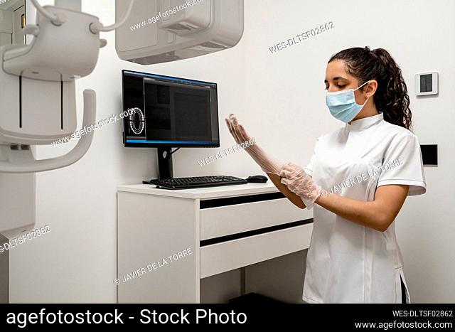 Nurse wearing protective glove in laboratory at maxillofacial clinic
