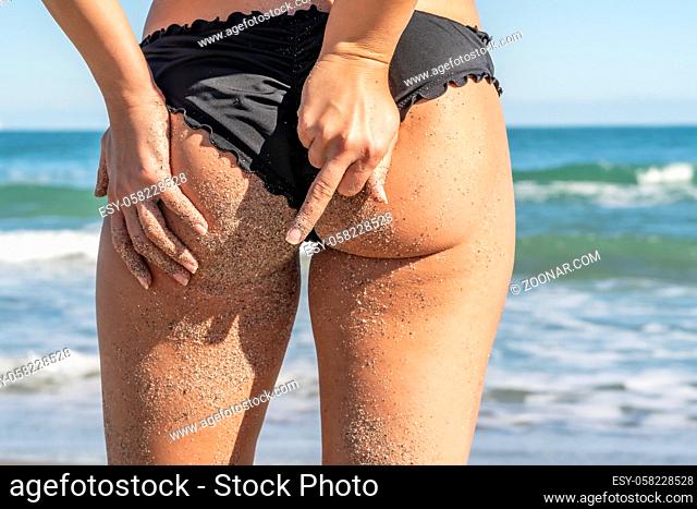 A gorgeous bikini model posing in a beach environment