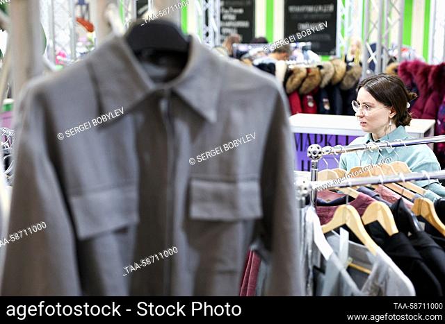 RUSSIA, MOSCOW - APRIL 28, 2023: A woman is seen amid clothing racks during the Moscow Fashion Week at the Oceania Shopping Centre