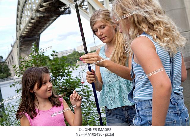 Girls fishing at river