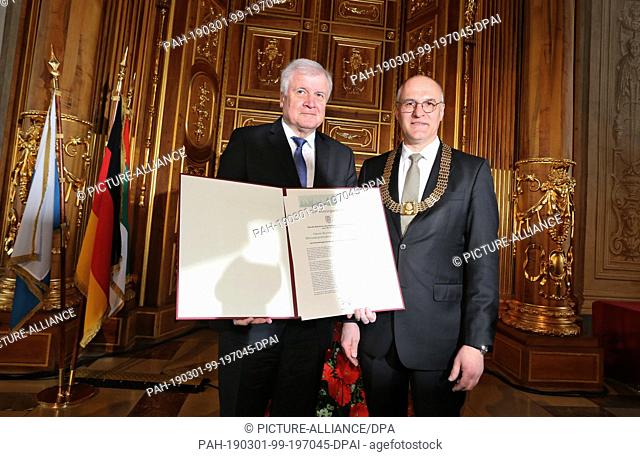 01 March 2019, Bavaria, Augsburg: Horst Seehofer, Federal Minister of the Interior (l, CSU) is awarded honorary citizenship of the city by Kurt Gribl (CSU)