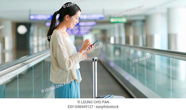 Woman use of smart phone in the airport