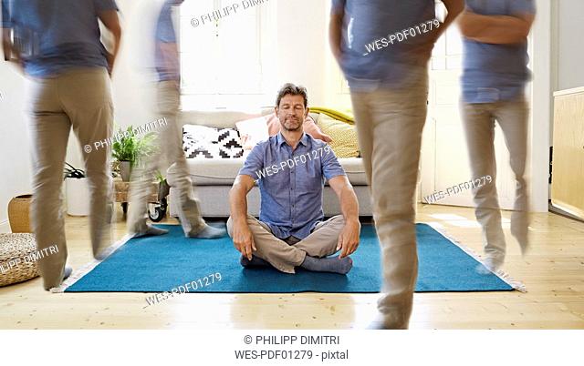 Man sitting on ground, meditating
