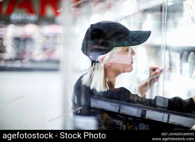 Woman looking at shelves in shop