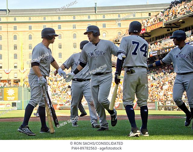 New York Yankees third baseman Chase Headley (12) celebrates with his teammates on the field after scoring his team's seventh and final run during their ninth...