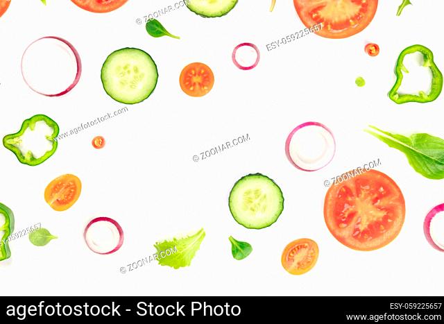 Fresh vegetable salad ingredients, shot from the top on a white background. A flat lay composition with tomato, pepper, cucumber