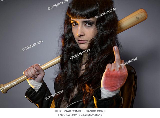Trouble, adolescence and delinquency, brunette woman in leather jacket and baseball bat with challenging aptitude