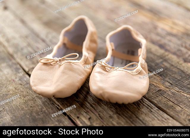 ballet shoes laying on rough vintage wood, with natural light, Ballet shoes for Kids