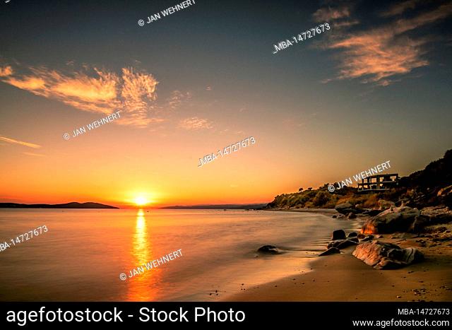 Sunset on the sandy beach of the village Ouranoupoli near Thessaloniki, Greece