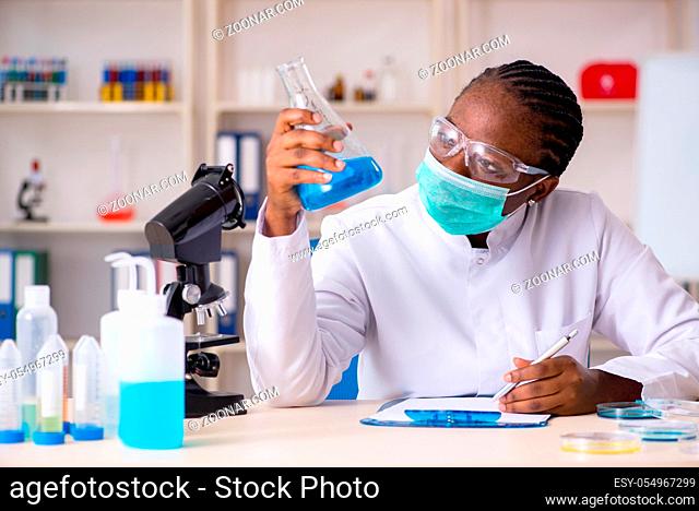 Young black chemist working in the lab
