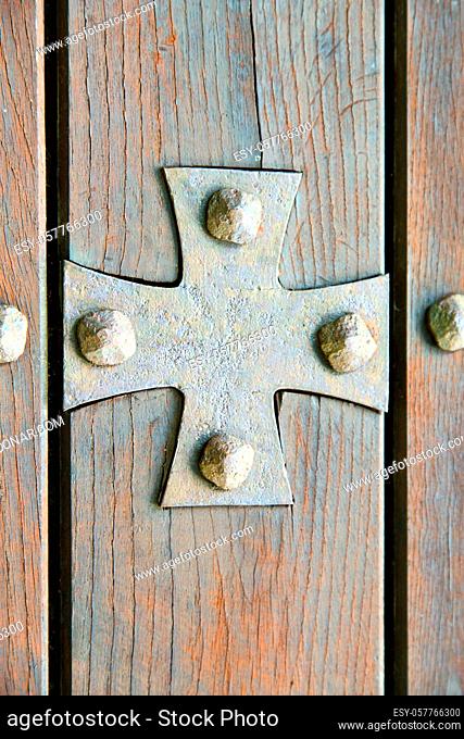 lombardy  arsago seprio abstract  rusty brass brown knocker in a door curch closed wood italy  cross