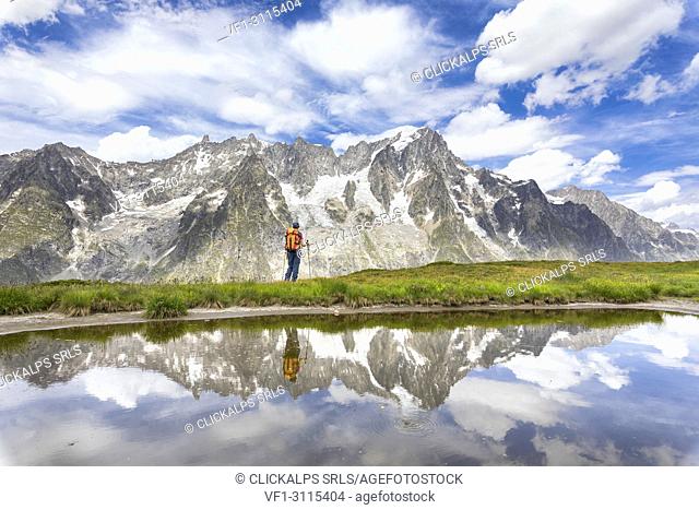 A girl is watching the Grandes Jorasses and the Mont Blanc Massif from the Mont de la Saxe during the Mont Blanc hiking tours (Ferret Valley, Courmayeur