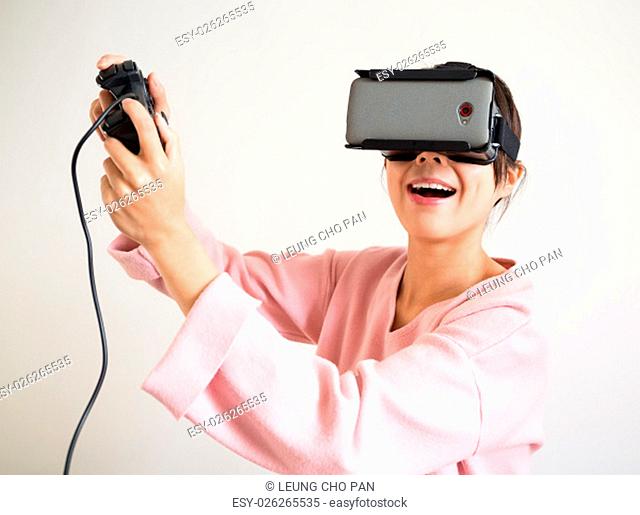Excite Woman in virtual reality glasses playing the game