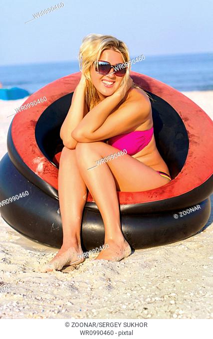 Cheerful girl sitting in an inflatable chair