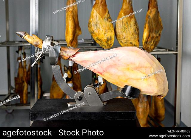 Iberian ham leg on holder at butcher's shop