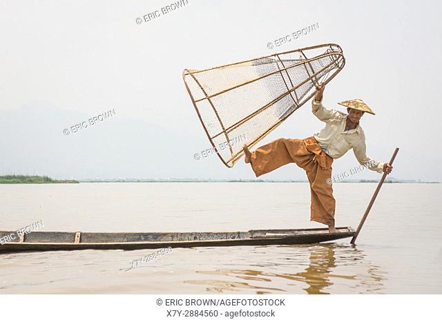 A fisherman poses for a photo. Inle Lake, Myanmar