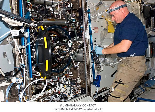 NASA astronaut Scott Kelly, Expedition 25 flight engineer, works on the Combustion Integrated Rack (CIR) Multi-user Drop Combustion Apparatus (MDCA) in the...