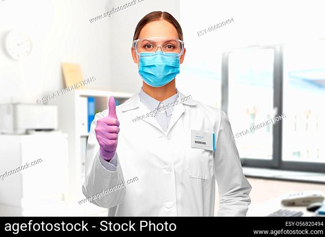 female scientist in medical mask and goggles
