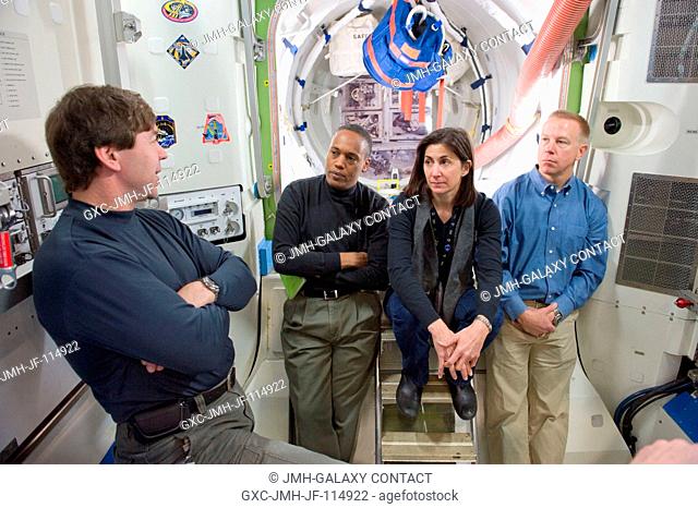NASA astronauts Michael Barratt (left), Alvin Drew, Nicole Stott and Tim Kopra, all STS-133 mission specialists, participate in a training session in an...