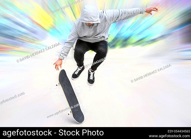 young skater doing jump trick at skate park