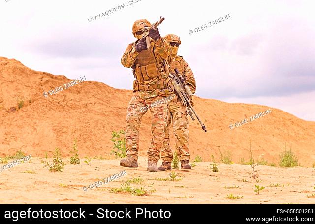 Equipped and armed special forces soldiershooting on the battlefield. Concept of military anti-terrorism operations, special operations of NATO forces