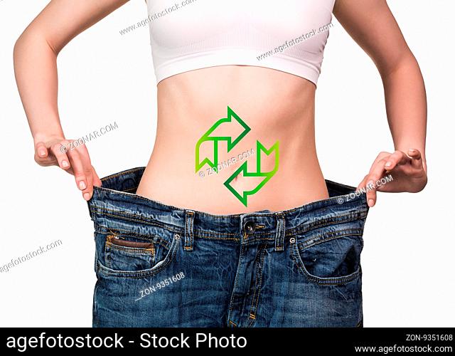 Woman holding big jeans with drawing arrows on her belly isolated on white
