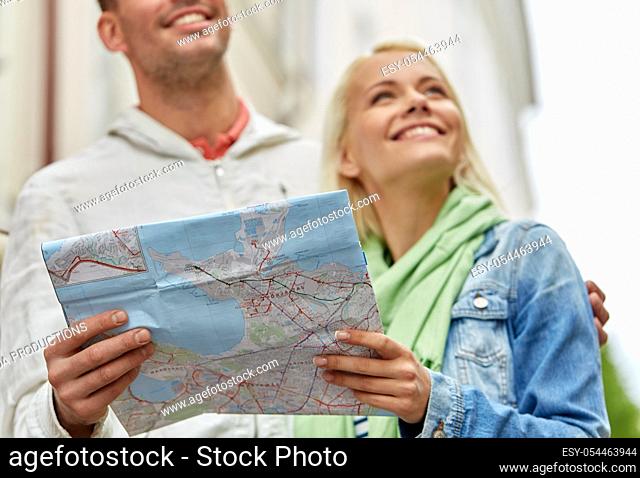 close up of happy couple with map exploring city