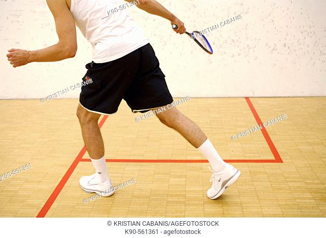 A man playing squash
