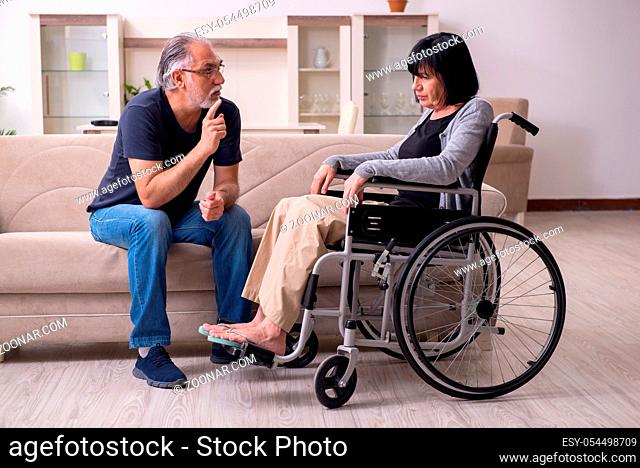 The old husband looking after disabled wife