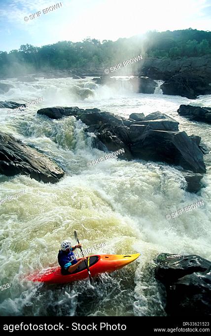 Kayaker running Maryland side of Great Falls on the Potomac River.; GREAT FALLS, POTOMAC RIVER, MARYLAND