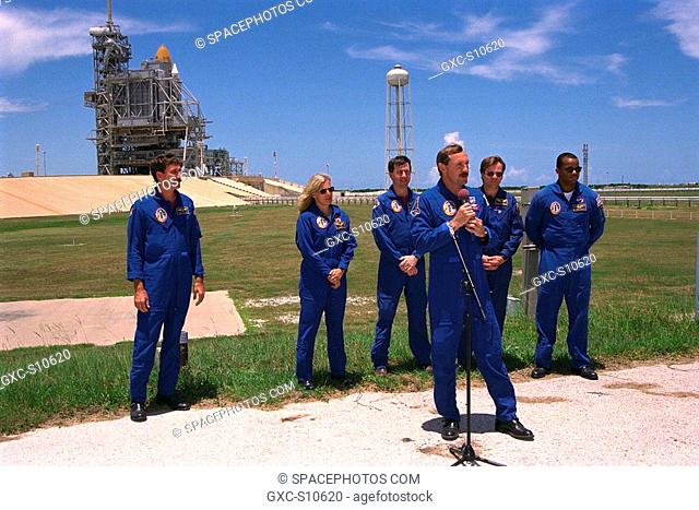 07/22/1997 -- STS-85 Commander Curtis L. Brown, Jr., addresses the news media at a briefing at Launch Pad 39A while the other members of the flight crew in the...