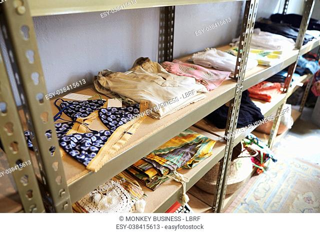 Clothing displayed on shelves in clothes shop, elevated view
