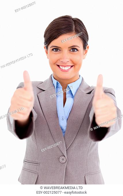 Close up of female entrepreneur giving thumbs up against a white background