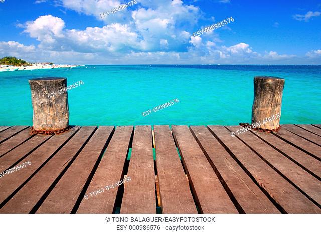Caribbean wood pier with turquoise aqua sea blue sky Mayan Riviera