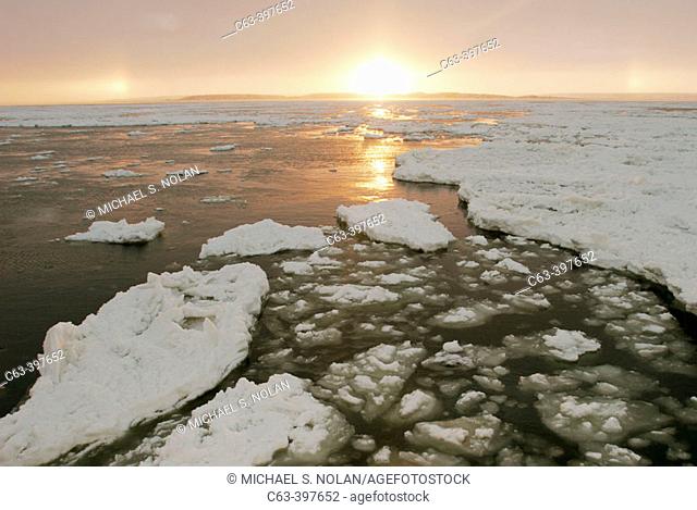 The Churchill River at sunset beginning to freeze-up in early November. Churchill, Manitoba, Canada