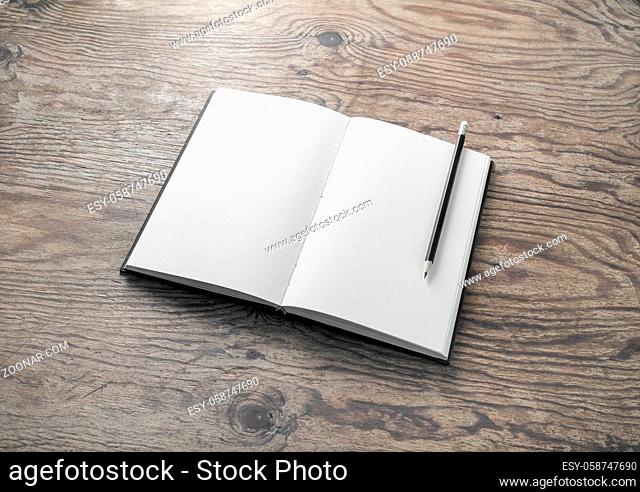 Photo of blank book and pencil on wooden background. Mockup of booklet