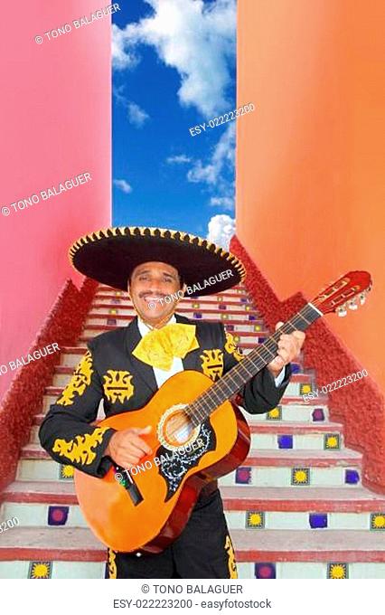 Charro Mariachi playing guitar in Mexico stairway