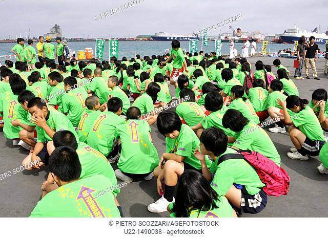 Naha (Japan): young students gathering as paddlers team at the Dragon Boat Festival