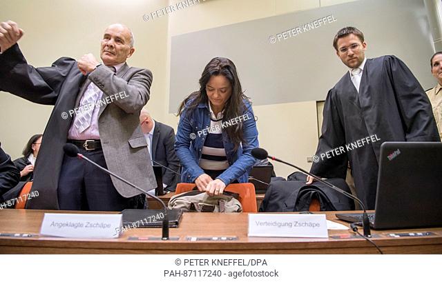 Defendant Beate Zschaepe arrives in the hearing room at the Oberlandesgericht (higher regional court) and sits down beside her lawyers Hermann Borchert (l) and...