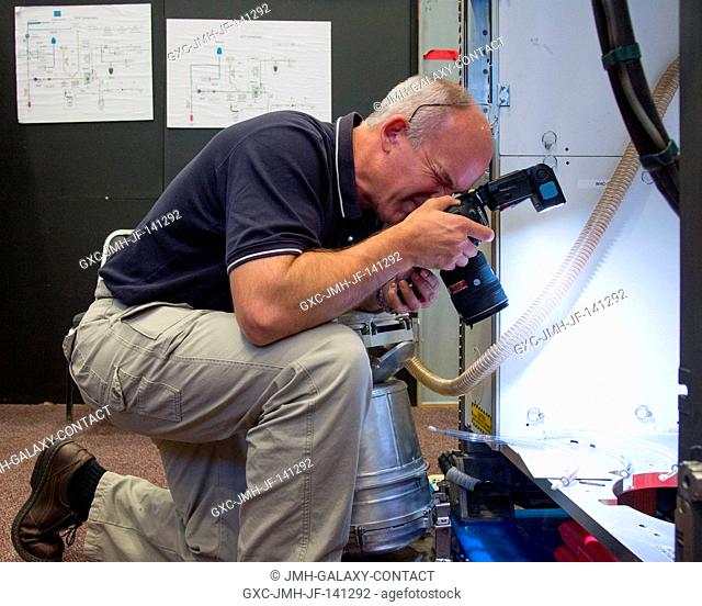 NASA astronaut Jeff Williams, Expedition 47 flight engineer and Expedition 48 commander, uses a still camera during a routine operations training session in an...