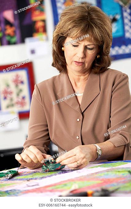 Woman Sewing Quilt