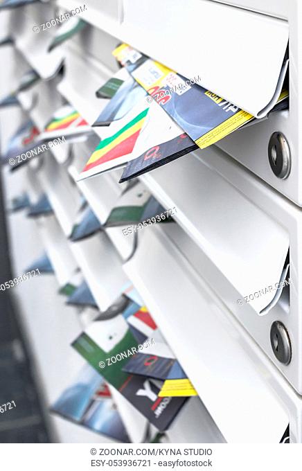 Modern mailboxes filled of leaflets. Business and advertising concepts. Shallow depth of field